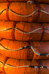 Close up of Orange lifebuoy on a boat in the port.