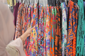 woman choosing clothes in shop.