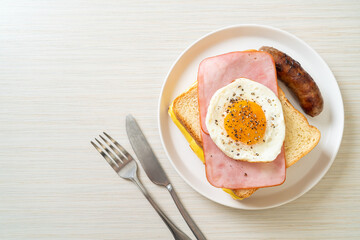 bread toasted cheese topped ham and fried egg with pork sausage