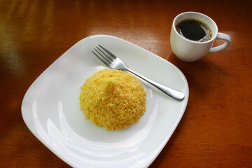 Brazilian breakfast. Coffee cup with corn couscous traditional in morning in Brazil.