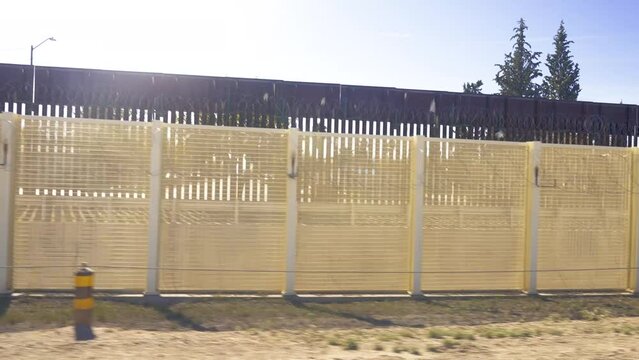 The Border Wall at the Arizona and Mexico border has two fences, one with barbed wire.