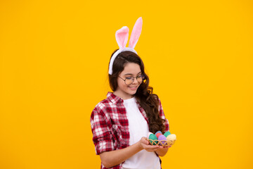 Little teen girl wearing bunny ears hold easter eggs, happy easter holidays. Happy teenager,...