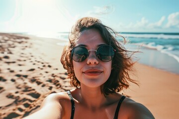 A young male traveler captures a selfie against the backdrop of a tropical beach and sea, embodying the spirit of adventure, vacation, wanderlust.