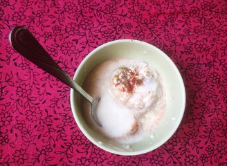 A snack originating from the Indian subcontinent called Dahi vada in local language and popular throughout South Asia. It is prepared by soaking fried flour balls in thick yogurt.