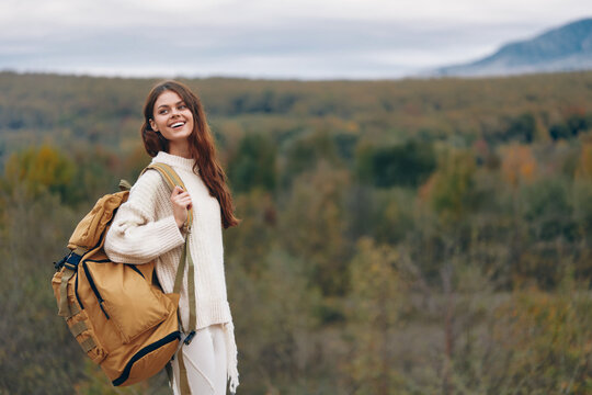 Mountain Adventure: Smiling Woman on Cliff, Enjoying Nature and Freedom.