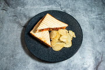 Vegetable crunchy sandwich with chips served in plate isolated on background top view of breakfast food indian spices
