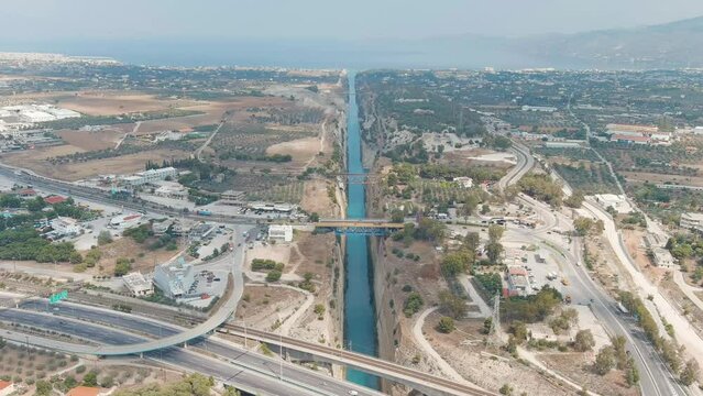 Dolly zoom. Corinth Canal, Greece. The Corinth Canal is a sluiceless shipping canal in Greece, connecting the Saronic Gulf of the Aegean and the Gulf of Corinth of the Ionian Sea, Aerial View, Depart
