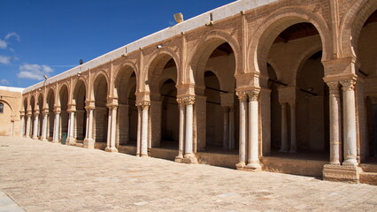 Inner courtyard surrounded by a patio supported by arches and columns in the Great Mosque of...