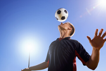 Football, bounce and head with man, game and training with competition, sunshine and exercise. Blue...