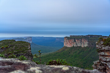 Majestic Sandstone Valley Surrounded by Vertical Cliffs and Silky Clouds