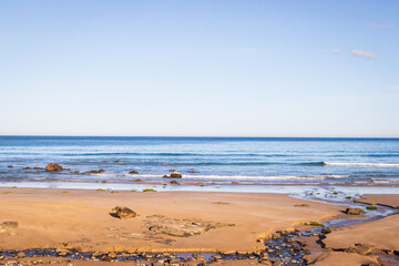 Serene Beachscape with Blue Skies and Gentle Waves
