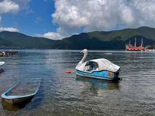 Hakone Lake Pier with touristic pedal goose boats and Mountain, Kanagawa Prefecture, Japan