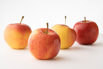 Fresh beautiful healthy apples on a white table and light gray background