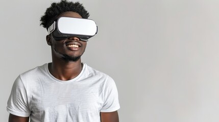 Smiling man on a white background while looking through a VR headset and making expressive gestures
