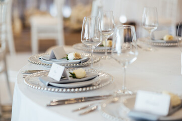 Cutlery and dishes on the table for guests at a wedding dinner in a restaurant