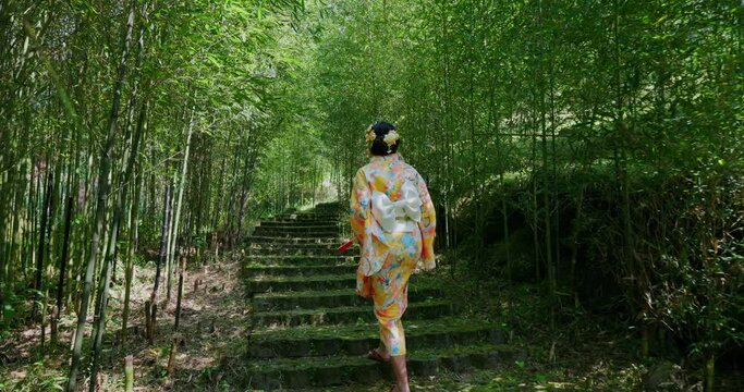 Woman wear kimono walk inside the forest