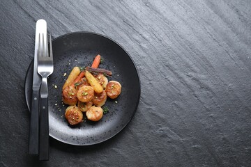 Delicious fried scallops served on dark gray textured table, top view. Space for text