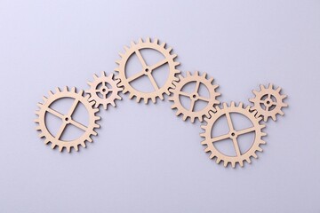 Business process organization and optimization. Scheme with wooden figures on light background, top view