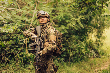SEALs from the Army are frontline soldiers ready to fight and check on enemies on the battlefield. They wear military uniforms, have M16 rifles, helmets, and vision goggles. The terrain is forest.