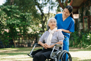 Fototapeta na wymiar Asian physiotherapist helping elderly woman patient stretching arm during exercise correct with dumbbell in hand during training hand with patient Back problems in the garden.