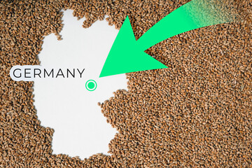 Map of Germany filled with wheat grain. Direction green arrow. Copy space. 