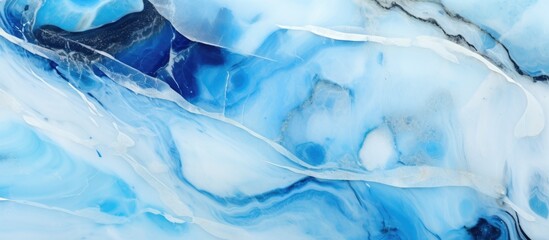 Obraz premium Close up view of a luxurious blue and white marble texture showcasing the polished surface of the natural stone.