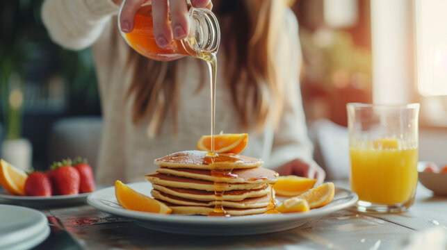 A woman delicately drizzles honey onto a stack of freshly cooked pumpkin pancakes, enhancing their warm, spiced flavors with a touch of sweetness. - Powered by Adobe