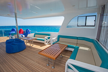 Fototapeta na wymiar Table and chairs on stern sun deck of a luxury motor yacht