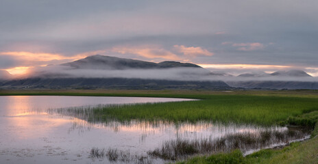 Fototapeta na wymiar Colorful sunset, lake and scenic landscape of Icelandic countryside