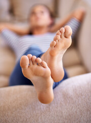 Woman, nap and feet to relax on couch, dream and lying while lazy or comfortable in home. Female...