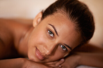 Obraz premium Portrait, peace and woman in spa to relax for vitality or wellbeing, luxury and pamper for body care or treatment. Female person, rest and calm or carefree for stress relief, zen wellness and therapy