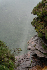 Misty Waterfall Cliff Edge Overlooking Verdant Valley