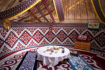 Kazak yurt interior with traditional felt carpets and furniture