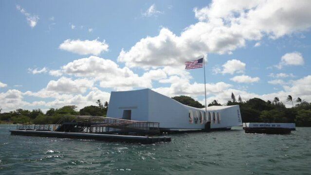 Tracking shot of pearl harbor memorial and American flag