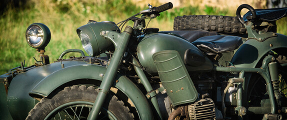 Fototapeta premium MILITARY MOTORCYCLE - An old Soviet machine in camouflage colors 