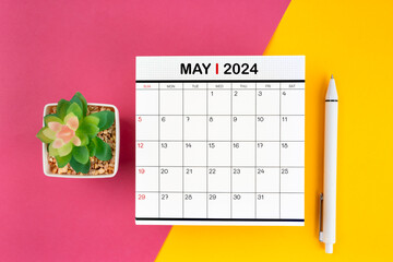 White calendar for May 2024 and pen on beautiful background.