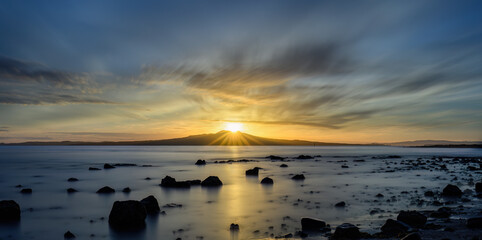 Long exposure image of sunrise at the top of Rangitoto Island. Takapuna Beach. Auckland.