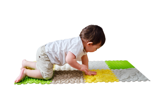Baby toddler foots close-up on a medical orthopedic mat, isolated on white background. Child legs with flat feet on a medical rug, isolated on white background. Kid aged one year four months