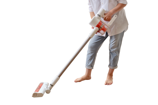 Woman with a wireless portable vacuum cleaner in the kitchen, isolated on a white background. Cleans the floor in an apartment with a vacuum cleaner with a battery