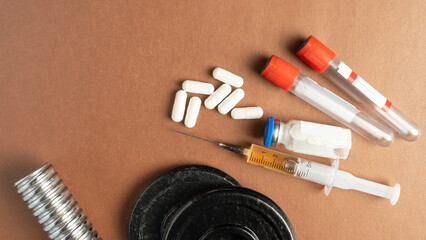 Syringe with doping and pills close-up, doping concept in sports.
