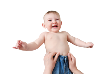 A mother woman puts on jeans pants for a baby boy, isolated on a white background. Mom dresses a happy child in clothes. Kid nine months old