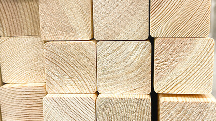 A stack of wooden blocks with a red background. The blocks are all different sizes and are piled on...