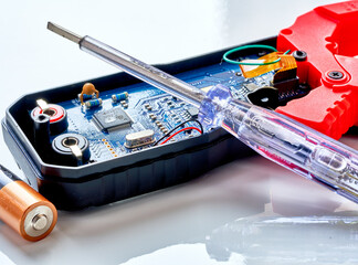 A screwdriver lies on a multimeter measuring device