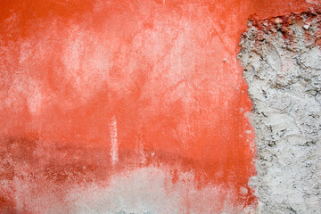 plastered concrete wall painted red in places