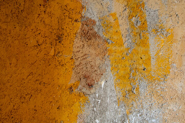 plastered concrete wall with yellow paint in some places