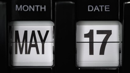 retro flip calendar with a date change from the sixteenth of May to the seventeenth of May. daily calendar with a change of days of the month. close up.