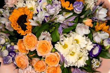 Tea roses and white garden chrysanthemums are among other flowers in the spring bouquet.