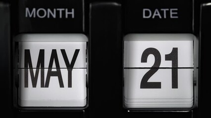 retro flip calendar with a date change from the twentieth of May to the twenty first of May. daily calendar with a change of days of the month. close up.