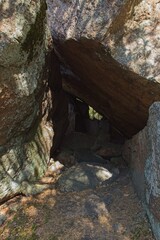 Rock formation of Korsvikin kivikirkko forming a cave in forest in summer, Pernaja, Finland.