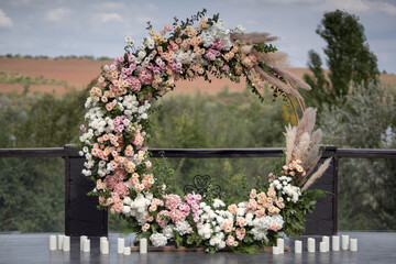 Wedding ceremony. Very beautiful and stylish wedding arch, decorated with various fresh flowers,...